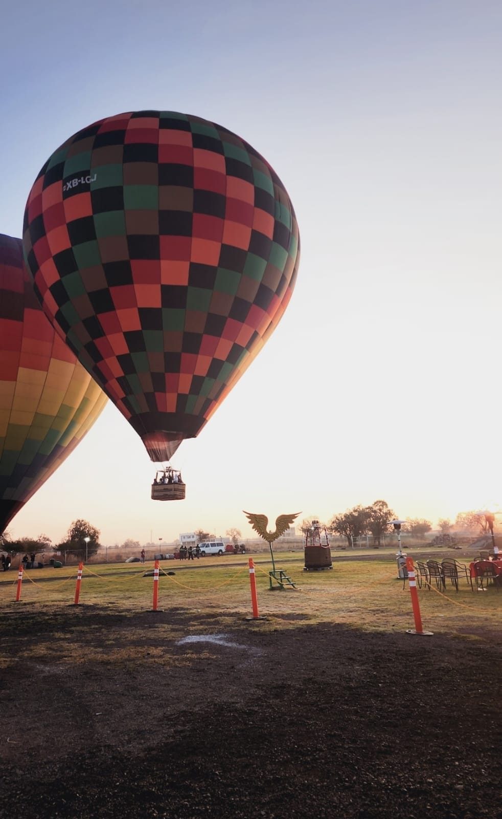 Hot air balloons rising over the Teotihuacan plain at dawn
